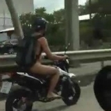 Video of a guy driving around Bangkok Naked on his KSR motorbike